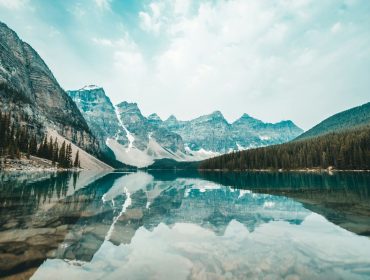 The mountains are reflected in a lake in banff national park.